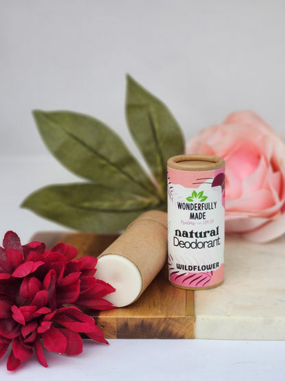 Natural deodorant stick in cardboard tube, Wildflower scent, pink label with floral art.