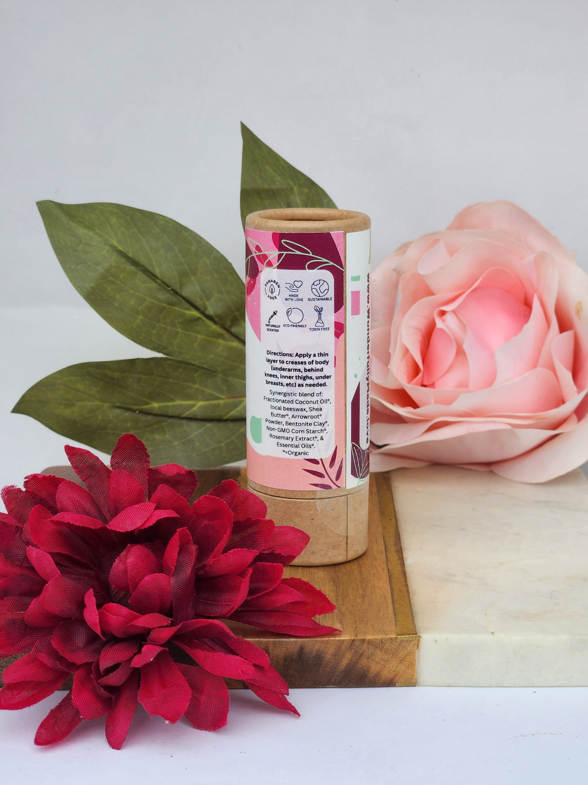 Natural deodorant stick in cardboard tube, back label with directions and product icons.