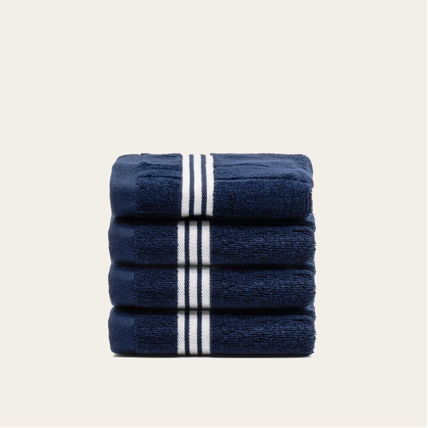 Rolled navy cotton towels with white striped bands