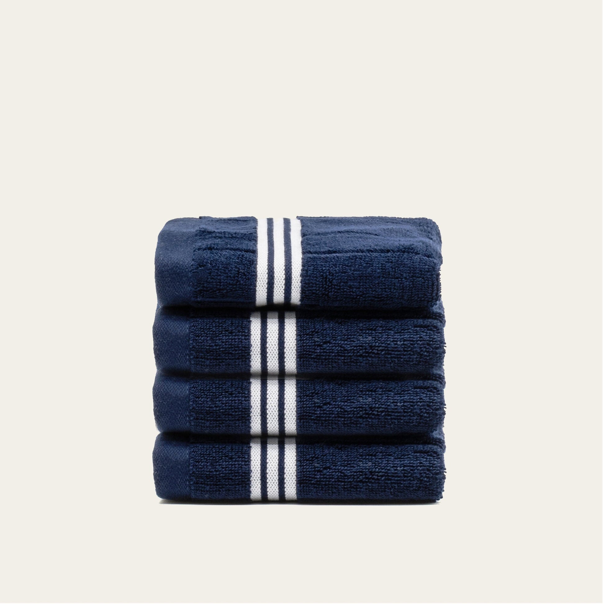Rolled navy cotton towels with white striped bands