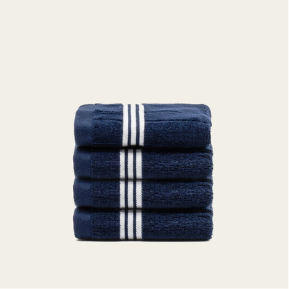 Rolled navy cotton towels with white striped bands