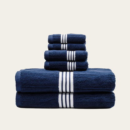 Two-fold stack of navy cotton towels with white striped bands
