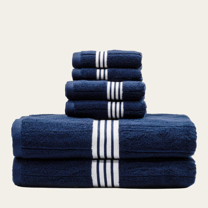 Navy cotton towels set with white striped bands, folded into a neatly stacked bundle.