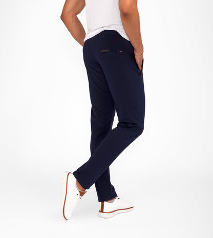 Navy tapered athletic sweatpants with drawstring waist and zippered side pockets