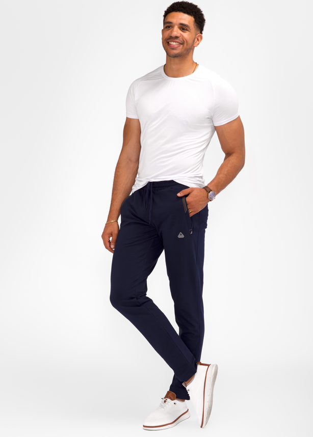 Navy tapered athletic sweatpants with elastic waistband and zippered side pockets