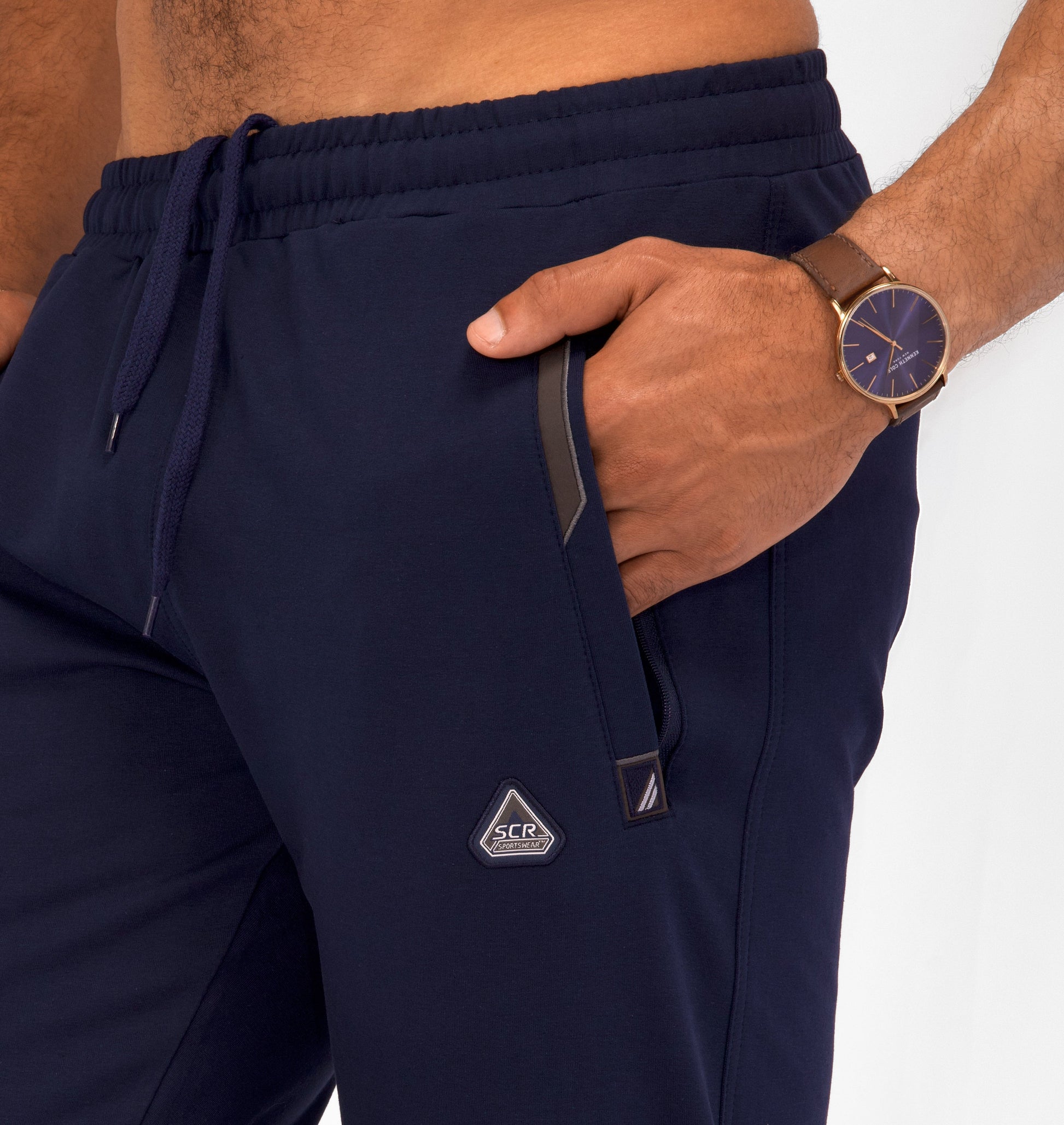 Navy tapered sweatpants with drawstring, elastic waistband, and side zip pocket
