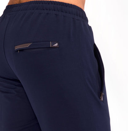 Navy tapered sweatpants back yoke with triangular brand patch and side zip pocket