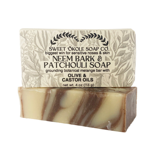 Neem Bark & Patchouli Soap bar, light beige with dark swirls and stamped leaf pattern