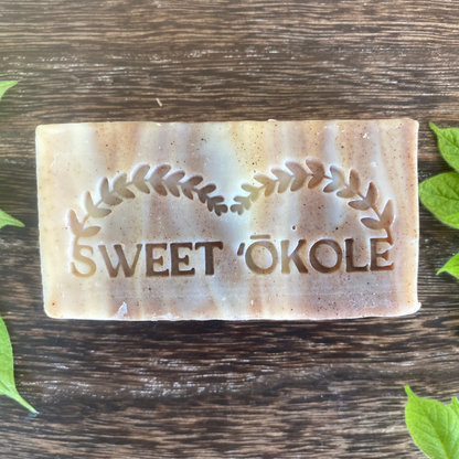 Neem Bark & Patchouli Soap bar with Sweet ’Ōkole stamped leaf emblem, cream and speckled