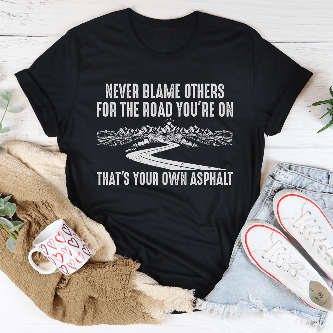 Black crewneck T-shirt with Never Blame Others asphalt road graphic (front)