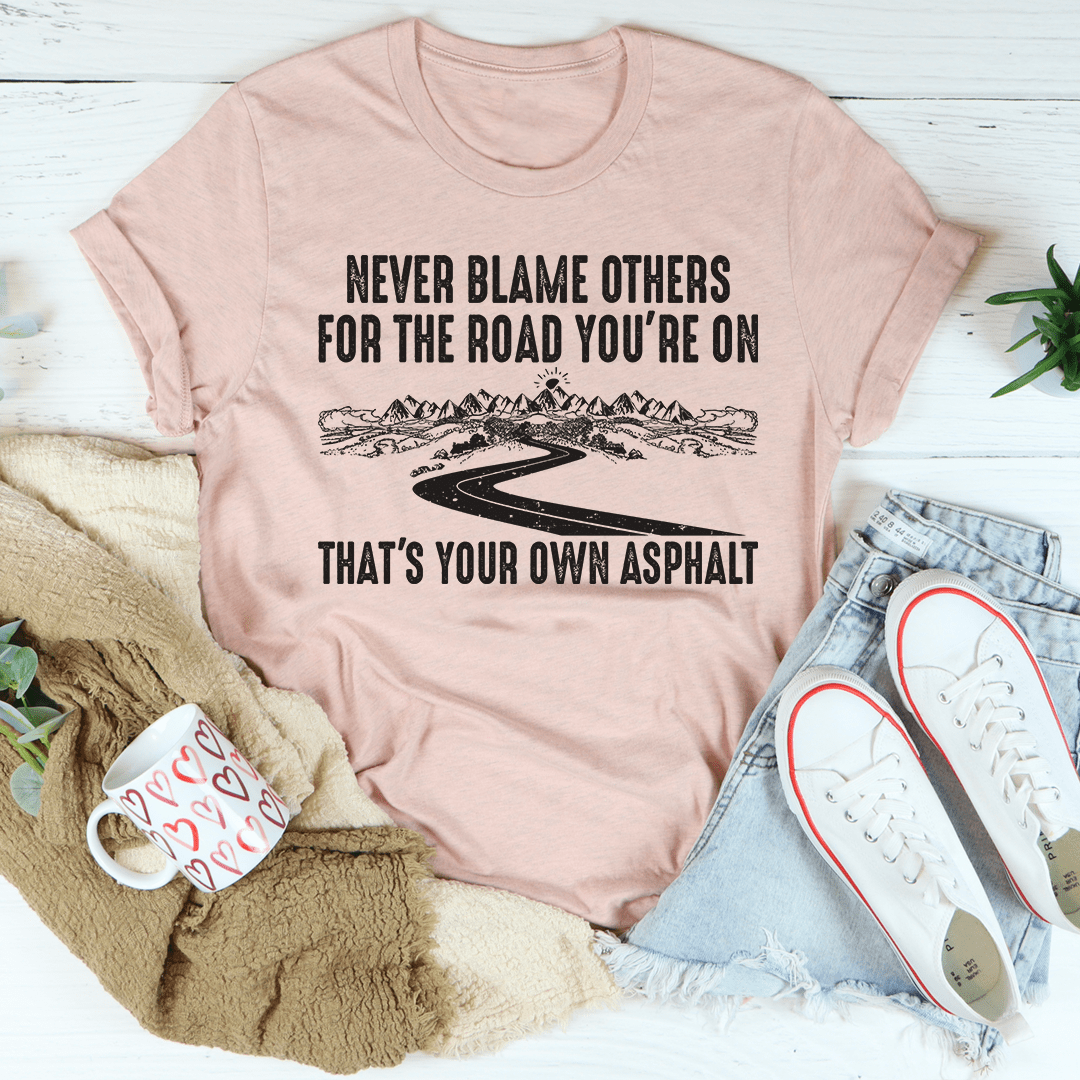 Heather prism peach crewneck T-shirt with Never Blame Others asphalt road graphic (front)