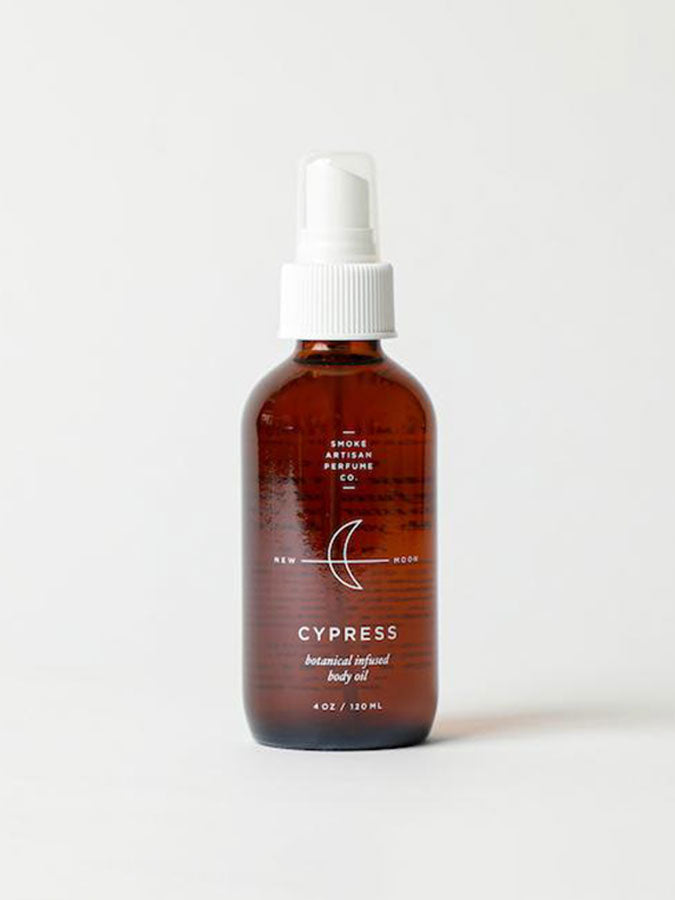 Cypress body oil bottle with amber glass and white pump, front label view
