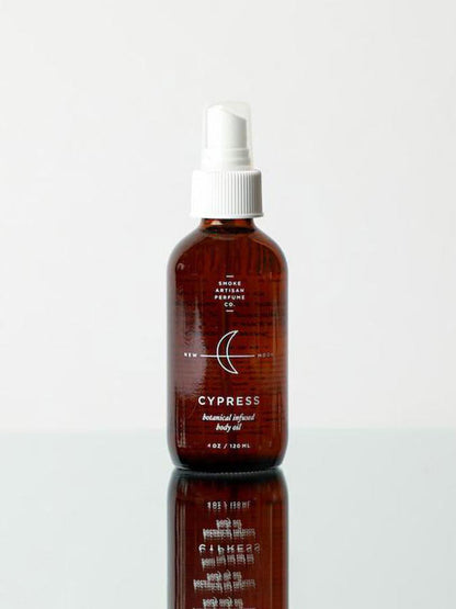 Cypress body oil bottle with white ribbed pump, front view with text visible