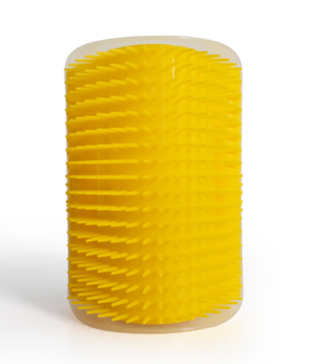 Yellow corner grooming brush with spiked bristles in a clear container.