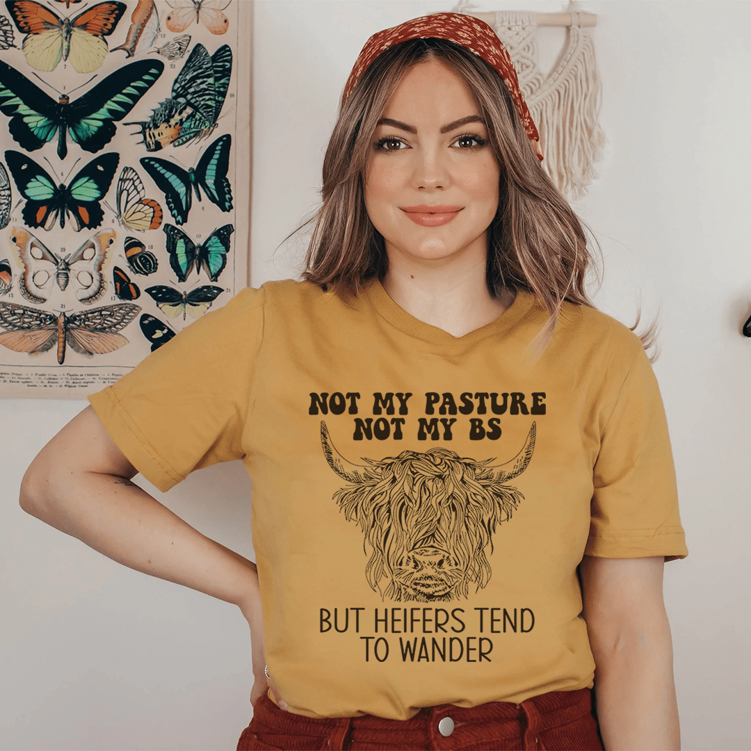 Mustard T-shirt on woman with cow head graphic and 'But heifers tend to wander' quote
