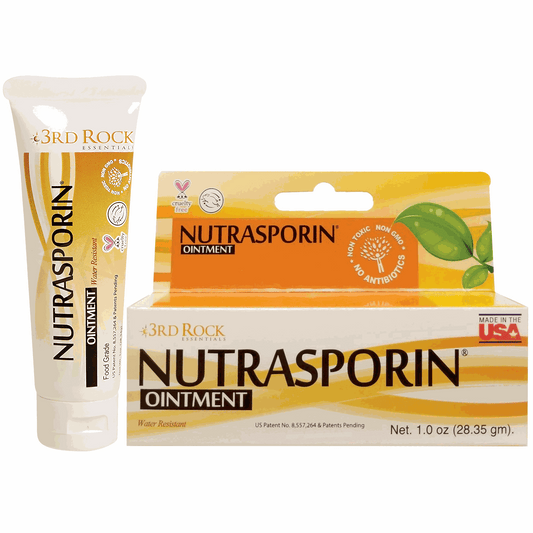 First aid ointment tube and carton, Nutrasporin brand, orange label with leaf graphic
