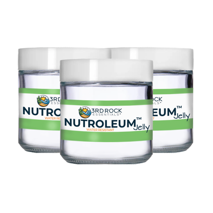 Skin balm jars with white lids and green label bands, front view