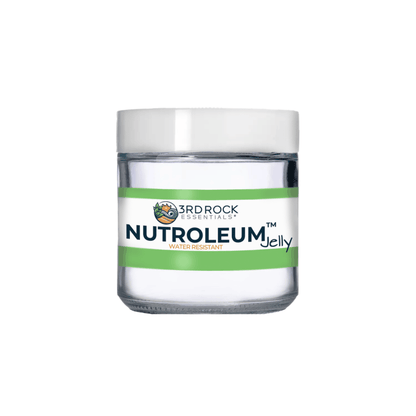 Skin balm jar with white lid and green band label, clear glass jar