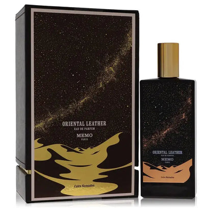 Unisex eau de parfum bottle with gold cap beside matching black gift box and label