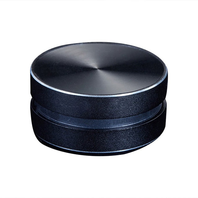 Black bone-conducting speaker with textured top and silver edge trim