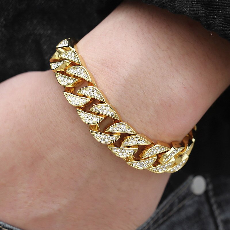 Gold curb Cuban bracelet with marquise crystal links on wrist