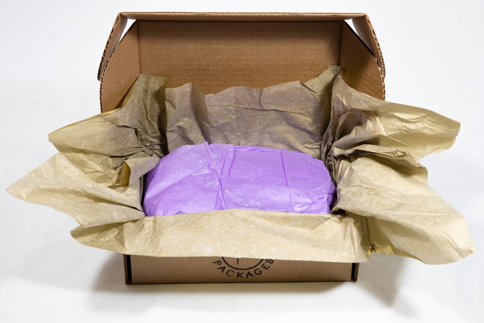 Open gift box with purple bar nestled in crinkled tissue paper