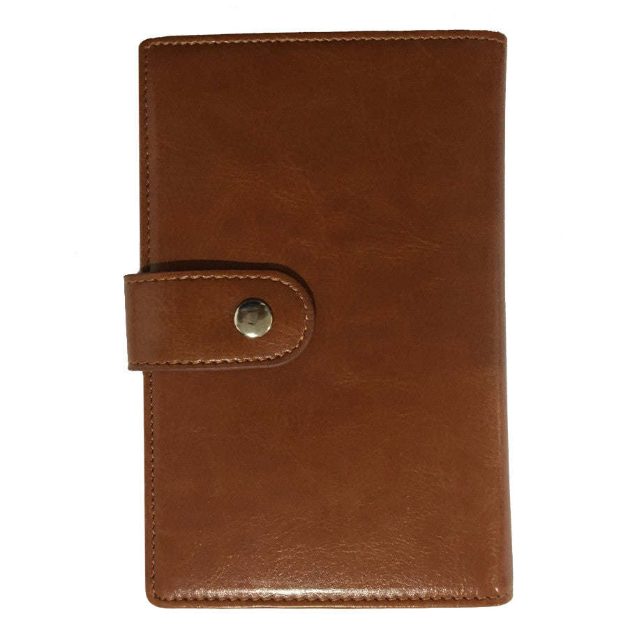 Brown passport wallet closed with snap button and strap tab