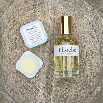 Phoebe Sweet Anthem perfume bottle with balm jar, white lid, and label card