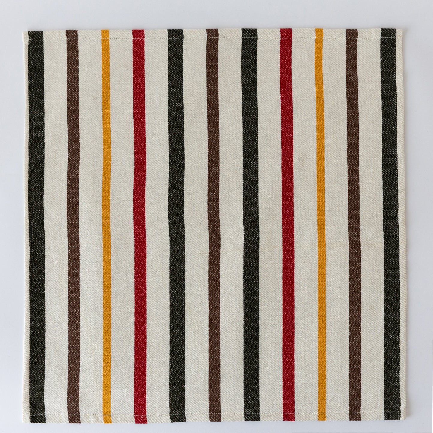 Striped cloth napkin with vertical bars in black, white, brown, red, and mustard