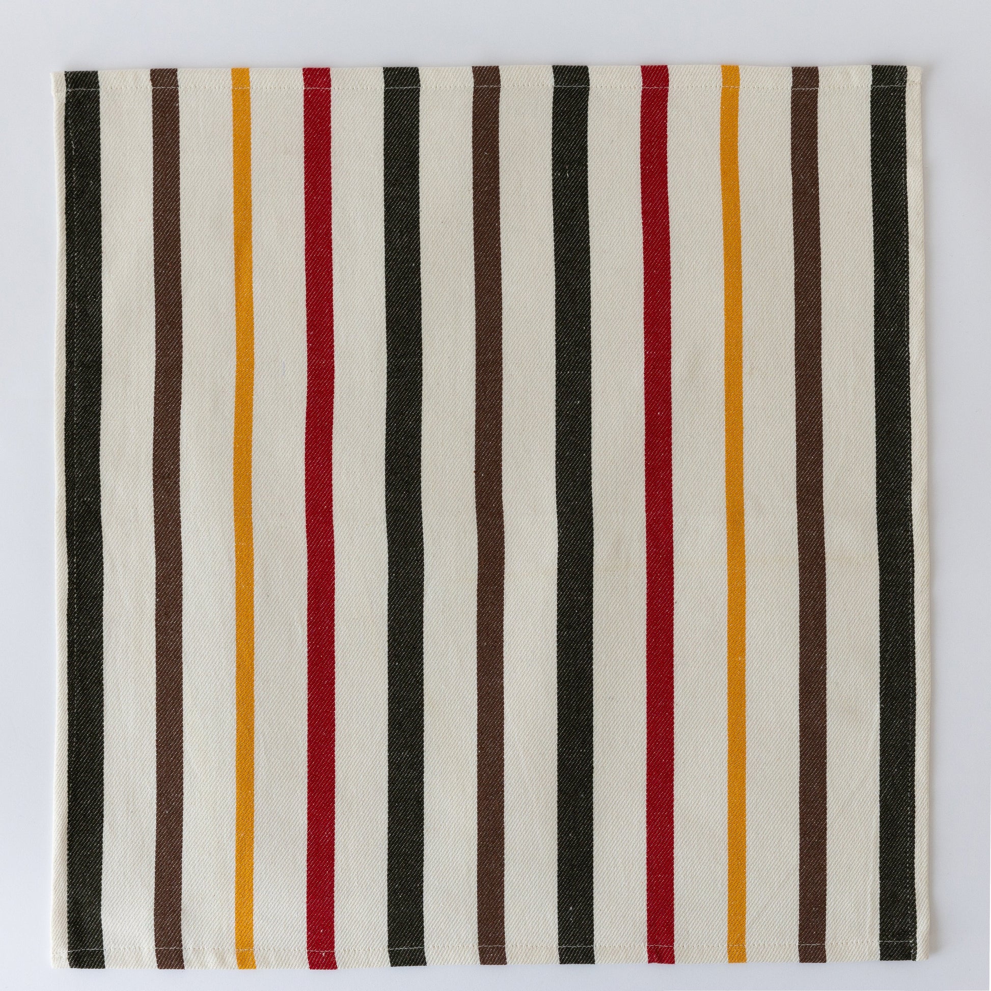 Striped cloth napkin with vertical bars in black, white, brown, red, and mustard