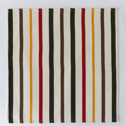 Striped cloth napkin with vertical bars in black, white, brown, red, and mustard