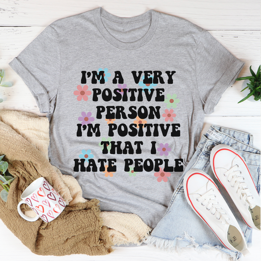 Grey crew-neck short-sleeve T-shirt with colorful flower “positive” text graphic