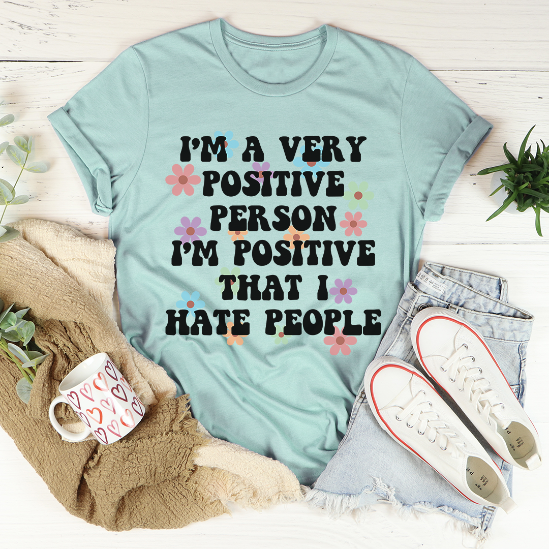 Teal graphic T-shirt with multicolor floral lettering and positive message