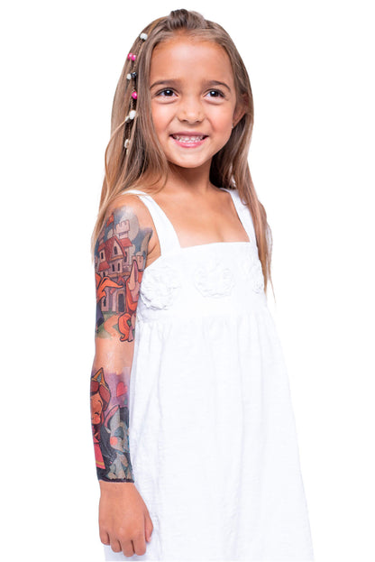 Child wearing a colorful temporary tattoo sleeve on left arm, castle graphics