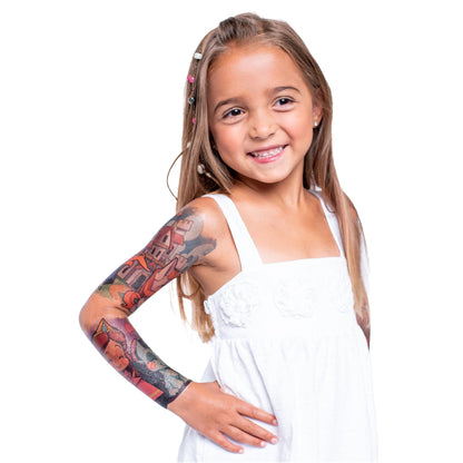 Child posing with temporary tattoo sleeve on left arm, detailed castle-style art