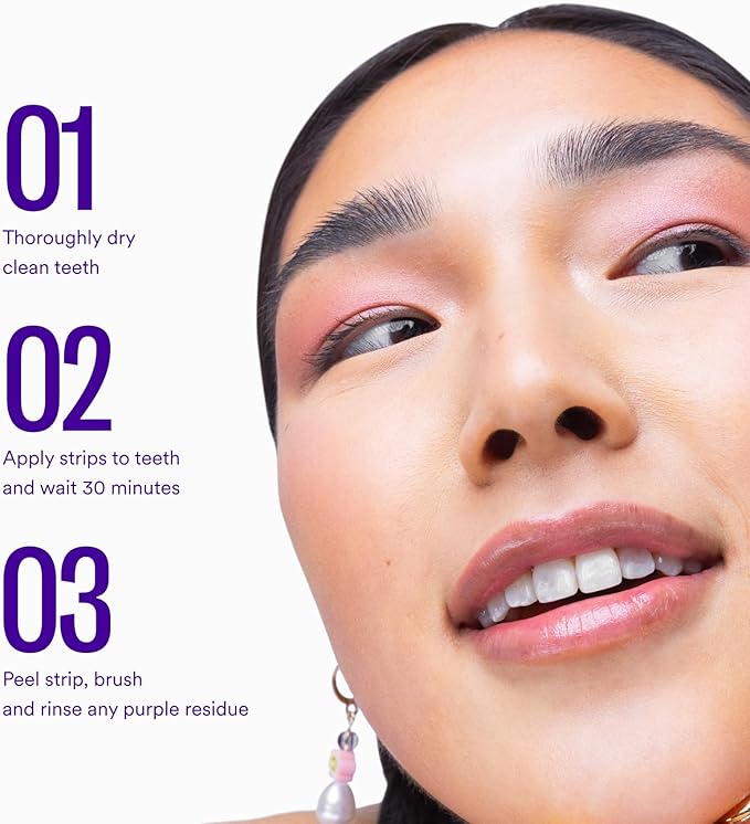 Smiling mouth with teeth showing purple whitening strip residue