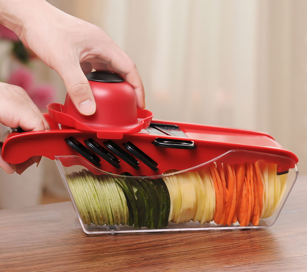 Red multifunction kitchen slicer with six blades and food container, for uniform slices.