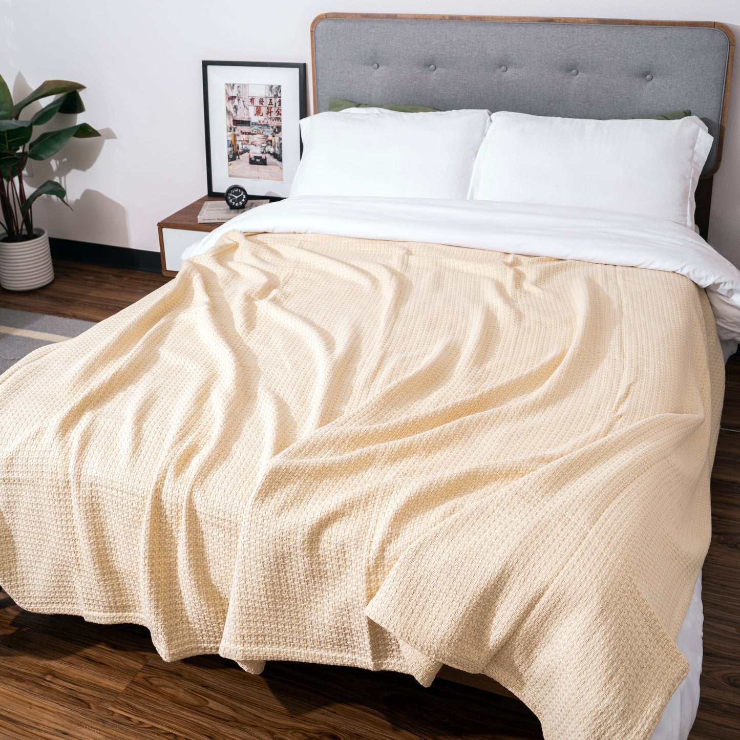 Beige basket-weave blanket spread across a bed