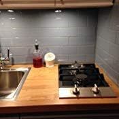 Stainless and black gas cooktop with 2 burners in an installed kitchen