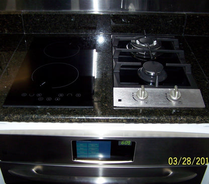 Countertop gas cooktop with 2 burners and control knobs in a kitchen setting