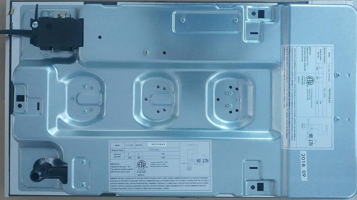 Underside view of a 2-burner gas cooktop with mounting clips and wiring points