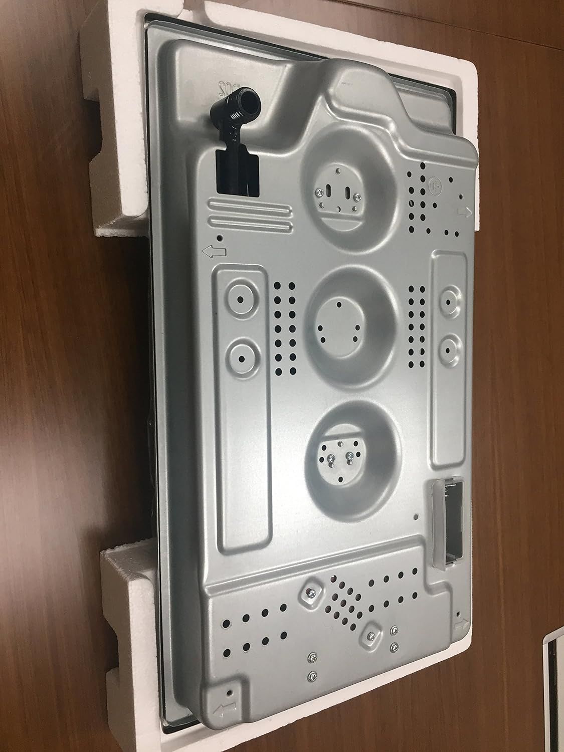 Gray metal cooktop mounting back panel with cutouts and screw holes