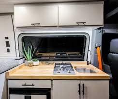 Built-in 2-burner gas cooktop in compact van kitchenette on a countertop