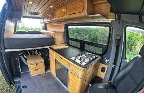 2-burner gas cooktop in van kitchenette with wood trim and surrounding counter