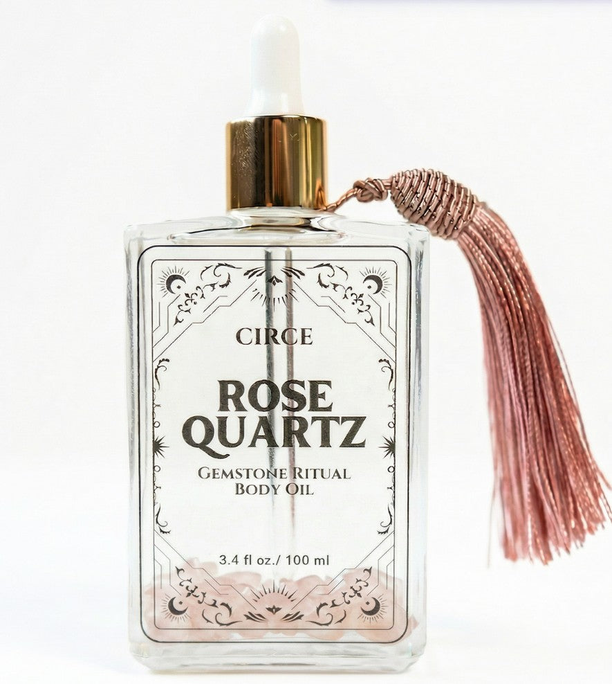 Rose Quartz gemstone body oil bottle with white dropper and rose-gold tassel