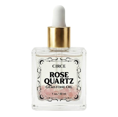 Rose Quartz gemstone body oil bottle with white dropper and gold cap