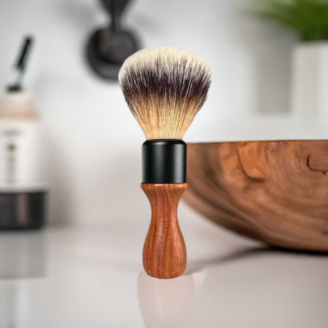 Shaving brush close-up with black ferrule, wood handle, and tapered soft bristles