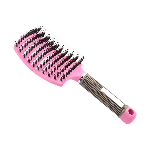Pink massage hair comb with textured grip handle and dense mixed bristles