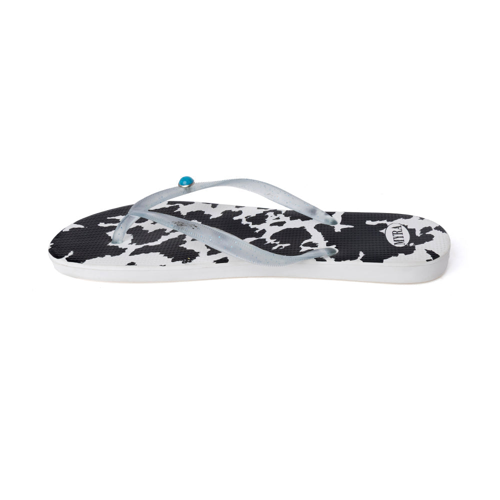 Cowhide slippers with black-and-white cow print straps and toe thong