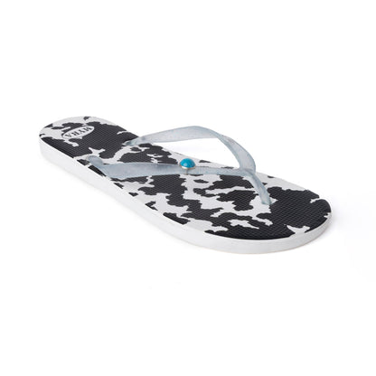 Cowhide slippers, black-and-white cow print with light blue thong; white sole
